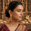 Gold Finish Trishul Shell Red Beads Jhumka Earrings