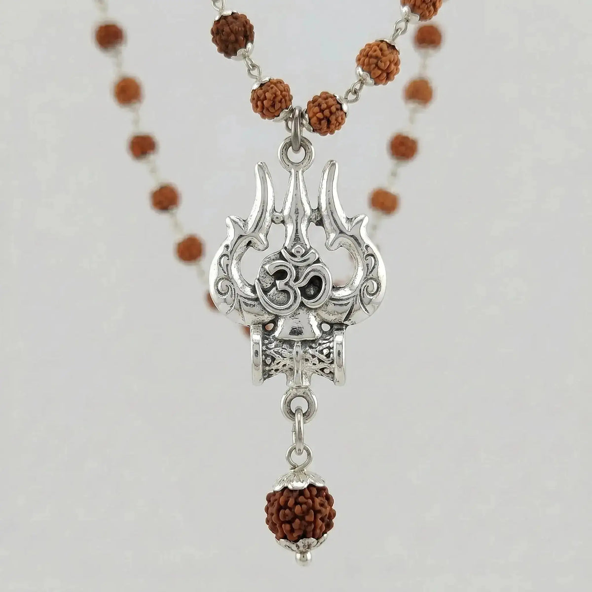 Close-up detail of Rudraksha beads with Shiva Trishool pendant